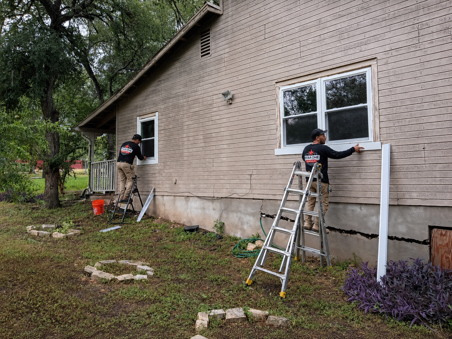 Star One Remodeling crew installing replacement windows and exterior trim